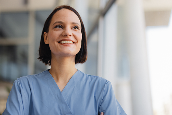 A nurse sits at a computer.