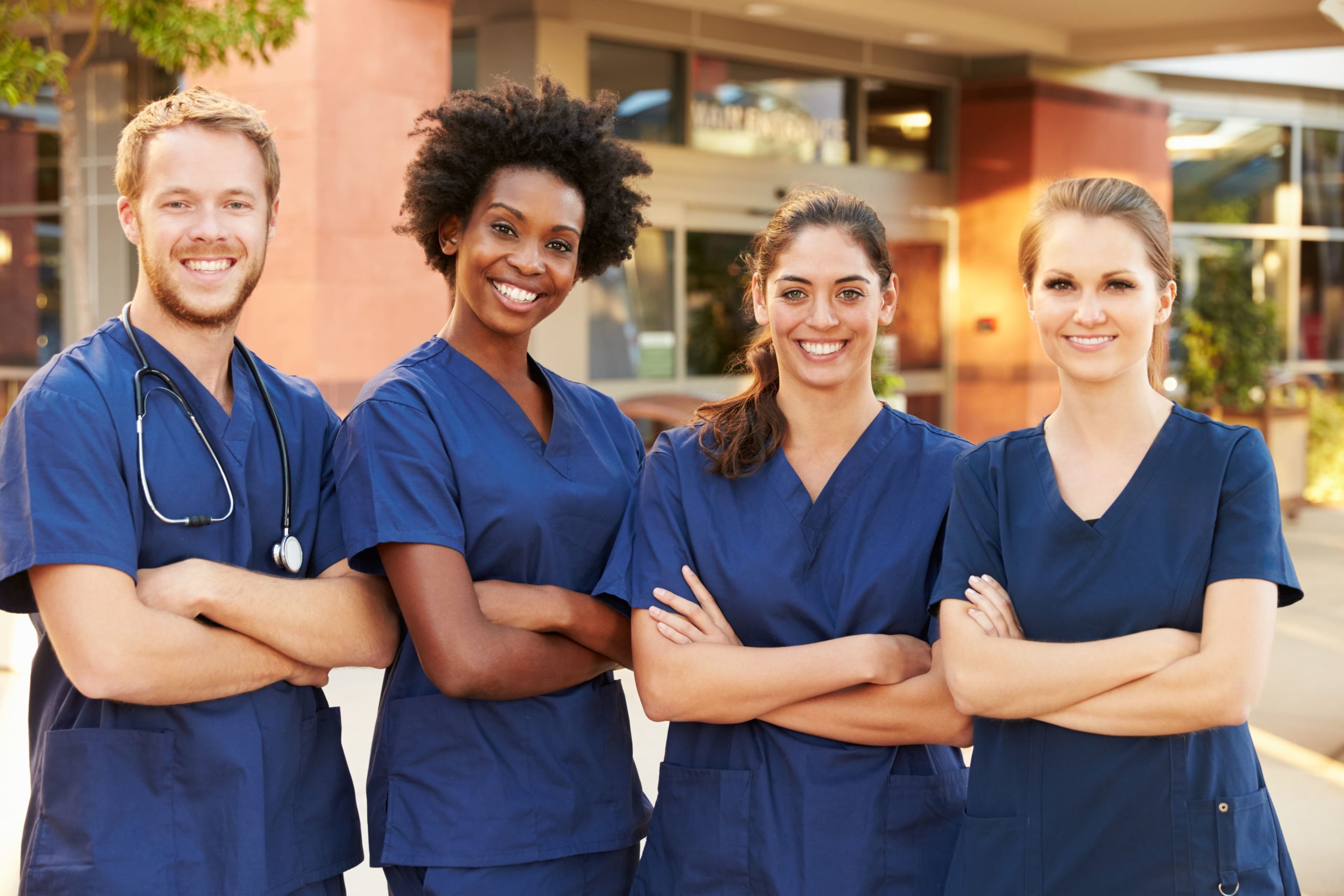 Smiling group of nurses in blue scrubs